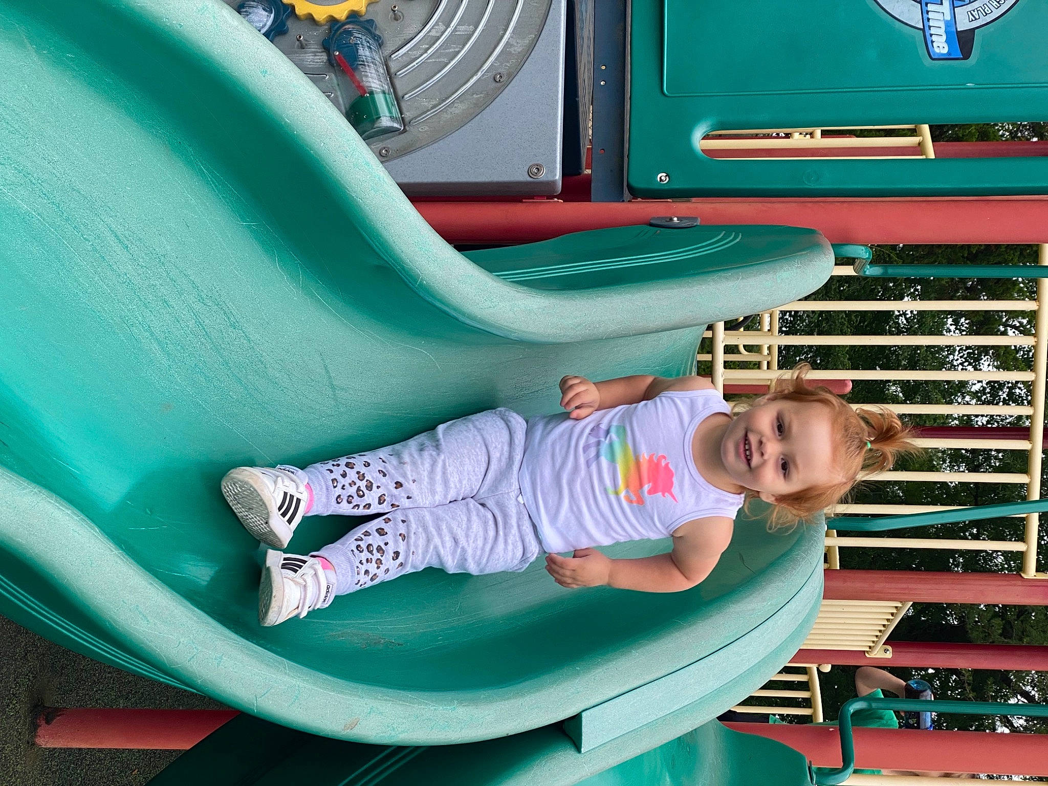 Emilee is registered to the contest to win money with this photo: automotive_exterior, baby_toddler_clothing, blue, child, chute, electric_blue, fun, green, joy, leisure, motor_vehicle, organ, person, pink, public_space, recreation, shoe, sitting, smile, snapshot