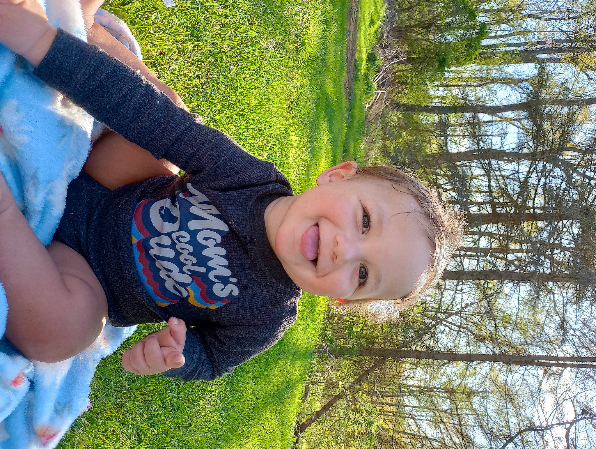 Beau is registered to the contest to win money with this photo: child, cool, facial_expression, fun, gesture, grass, grassland, happy, joy, laugh, leisure, people_in_nature, person, plant, play, recreation, sitting, smile, t_shirt, toddler