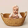 baby, infant, basket, headband, pink, cute, child, portrait, studio, woven_basket, smiling, hands, looking, expression, clothing, isolated, background, sitting, young, adorable