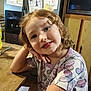 Haisley Mae is registered to the contest to win money with this photo: child, curly_hair, smiling, butterfly_shirt, table, kitchen, drawing, fridge, wooden_table, portrait, cute, indoor, person, happy, young, jewelry, cabinet, microwave, drink_bottle, casual_clothing