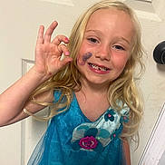 Tinsley Jo joined the competition — help win amazing prizes! child, girl, blonde_hair, blue_dress, face_paint, hand_gesture, smiling, teeth, door, doorknob, indoor, portrait, happy, cute, young, long_hair, sparkle, hand, gesture, seahorse_tattoo