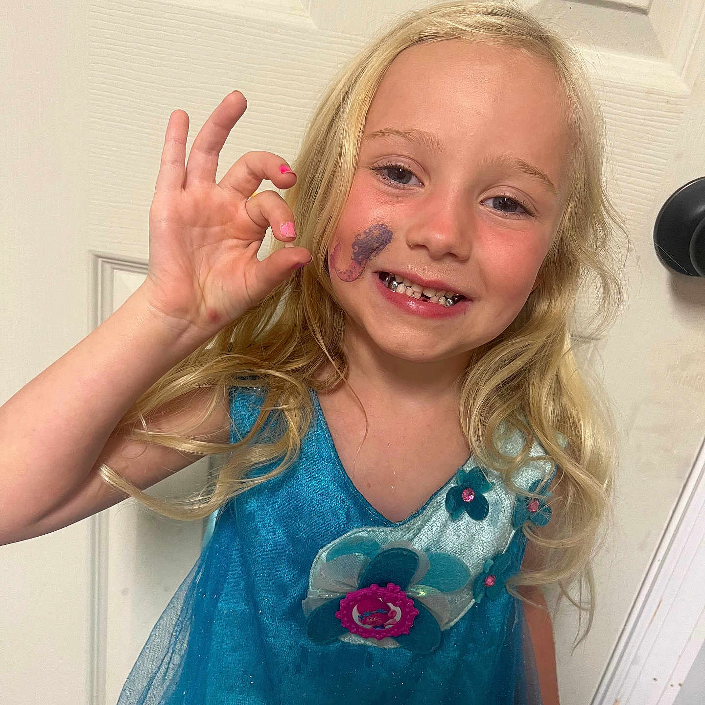 Tinsley Jo joined the competition — help win amazing prizes! blonde_hair, blue_dress, child, cute, door, doorknob, face_paint, gesture, girl, hand, hand_gesture, happy, indoor, long_hair, portrait, seahorse_tattoo, smiling, sparkle, teeth, young