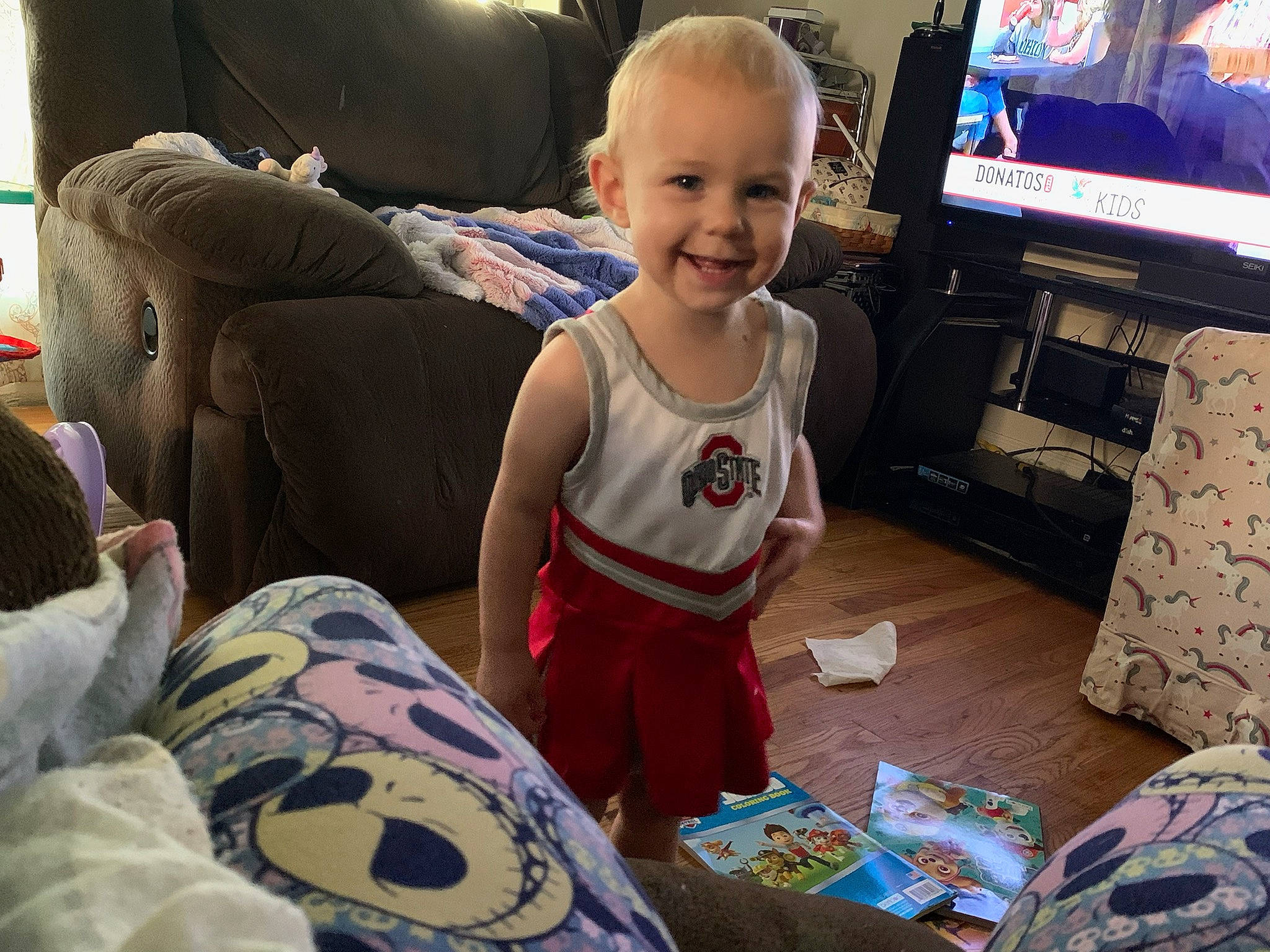 Aurora is registered to the contest to win money with this photo: baby, baby_toddler_clothing, child, comfort, couch, electronic_device, event, fun, gadget, happy, holiday, joy, lap, living_room, person, play, room, sitting, smile, t_shirt