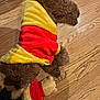 Guissepi joined the competition — help win amazing prizes! dog, curly_fur, hoodie, red, yellow, plush_toy, bear, wooden_floor, pet, indoor, laying_down, toy, brown, cozy, clothing, cute, animal, flooring, relaxed, soft_toy