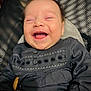 baby, laughing, smiling, face, infant, clothing, embroidered, pattern, blanket, happy, cute, child, portrait, closeup, joy, human, young, skin, head, expression