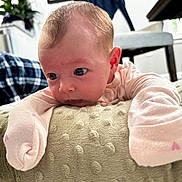 Elliana joined the competition — help win amazing prizes! baby, infant, child, cushion, pink_clothing, soft_texture, indoor, home, furniture, curious, portrait, closeup, face, head, person, newborn, toddler, sleepwear, cozy, light