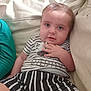 George is registered to the contest to win money with this photo: baby, child, couch, striped_clothing, plush_toy, indoor, person, sitting, cute, comfort, relaxing, candid, portrait, infant, casual, home, soft_lighting, curious, background_child, striped_shorts