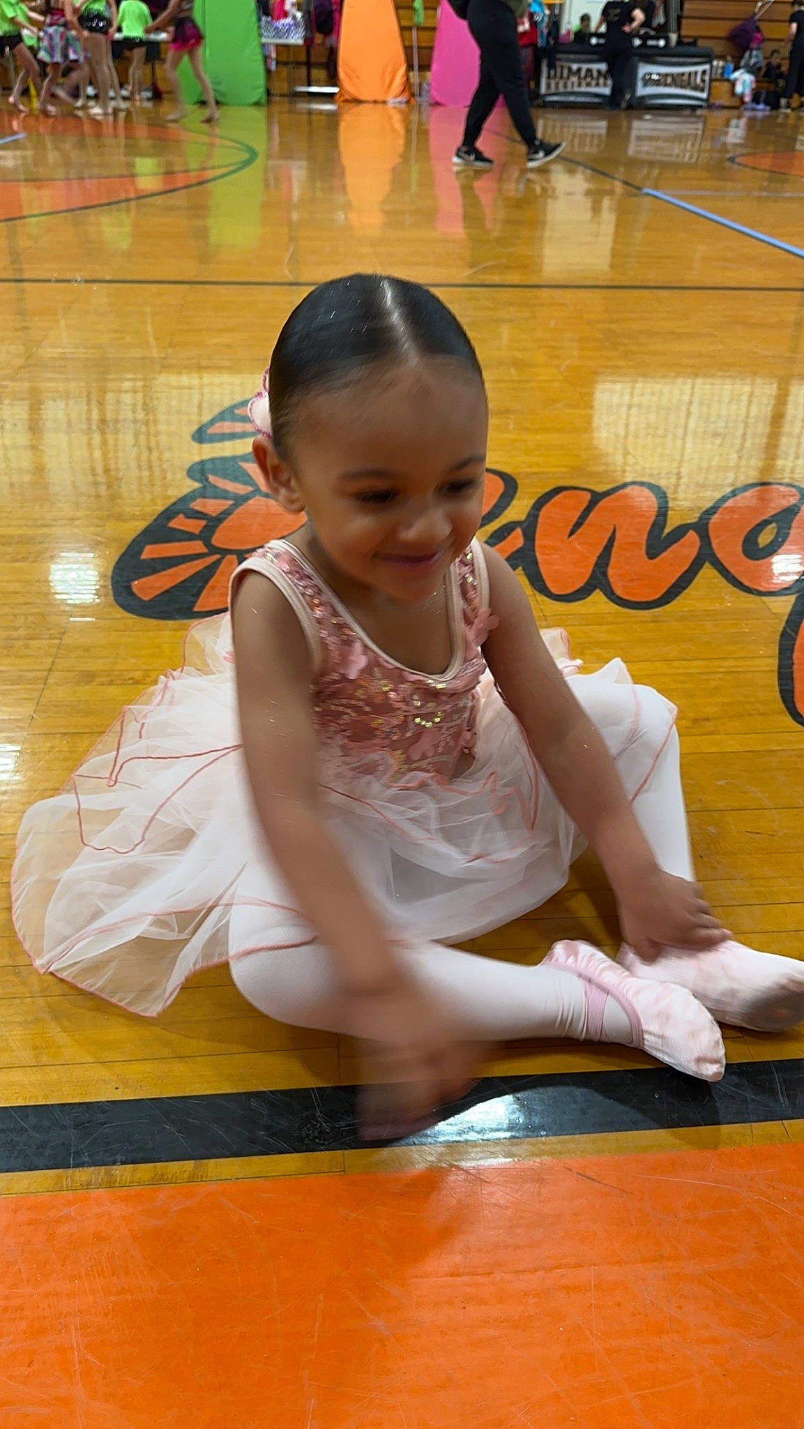 Ashantaya is registered to the contest to win money with this photo: barefoot, entertainment, event, floor, flooring, fun, happy, hardwood, human_leg, joint, joy, knee, leisure, performing_arts, person, sitting, smile, sportswear, thigh, toddler