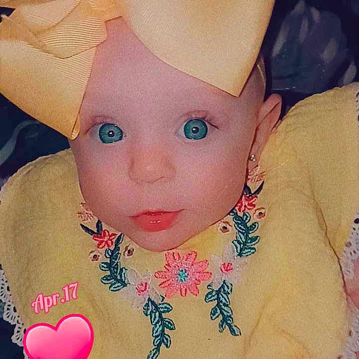 Stormie is registered to the contest to win money with this photo: accessories, baby, bonnet, clothing, costume, couch, cushion, doll, dress, face, furniture, hat, head, homedecor, jewelry, necklace, person, photography, portrait, toy