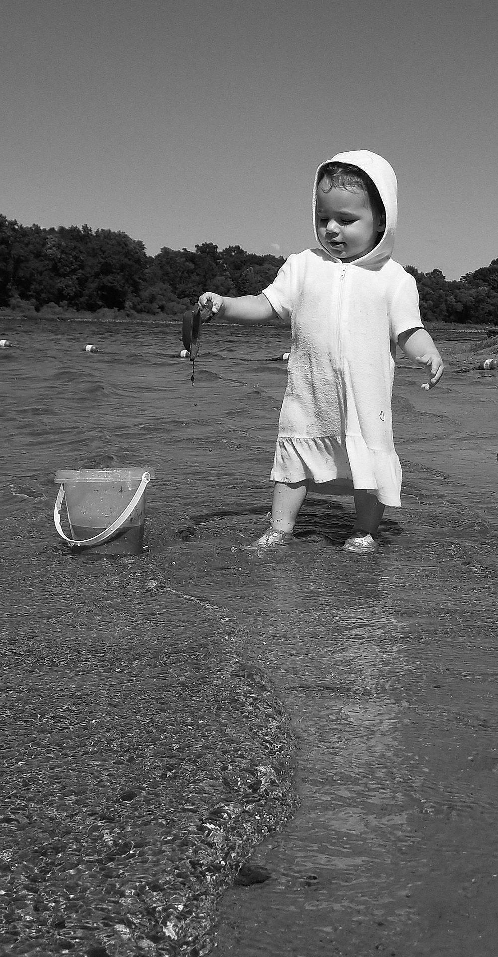 Adelynne is registered to the contest to win money with this photo: black, black_and_white, child, cloud, daytime, fun, human, male, monochrome, monochrome_photography, person, photograph, photography, reflection, sand, sea, sky, standing, water, white