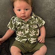 Albie joined the competition — help win amazing prizes! baby, child, infant, hair, green_shirt, shorts, sitting, couch, curious, blue_eyes, portrait, indoor, clothing, cute, young, person, expression, skin, casual, comfortable