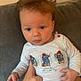 baby, child, infant, face, hair, blue_clothing, couch, hand, person, sitting, cute, indoor, portrait, expression, paddington_bear, long_sleeve_shirt, skin, young, holding, curious