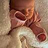 baby, newborn, sleeping, blanket, pink_clothing, cozy, soft, infant, cute, peaceful, face, child, warm, rest, portrait, closeup, toddler, snuggle, bedtime, comfort