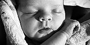 Ronnie joined the competition — help win amazing prizes! baby, black_and_white, blanket, child, close_up, cute, face, hand, infant, newborn, peaceful, portrait, rest, serene, skin, sleeping, soft_texture, tender, wrapped, young
