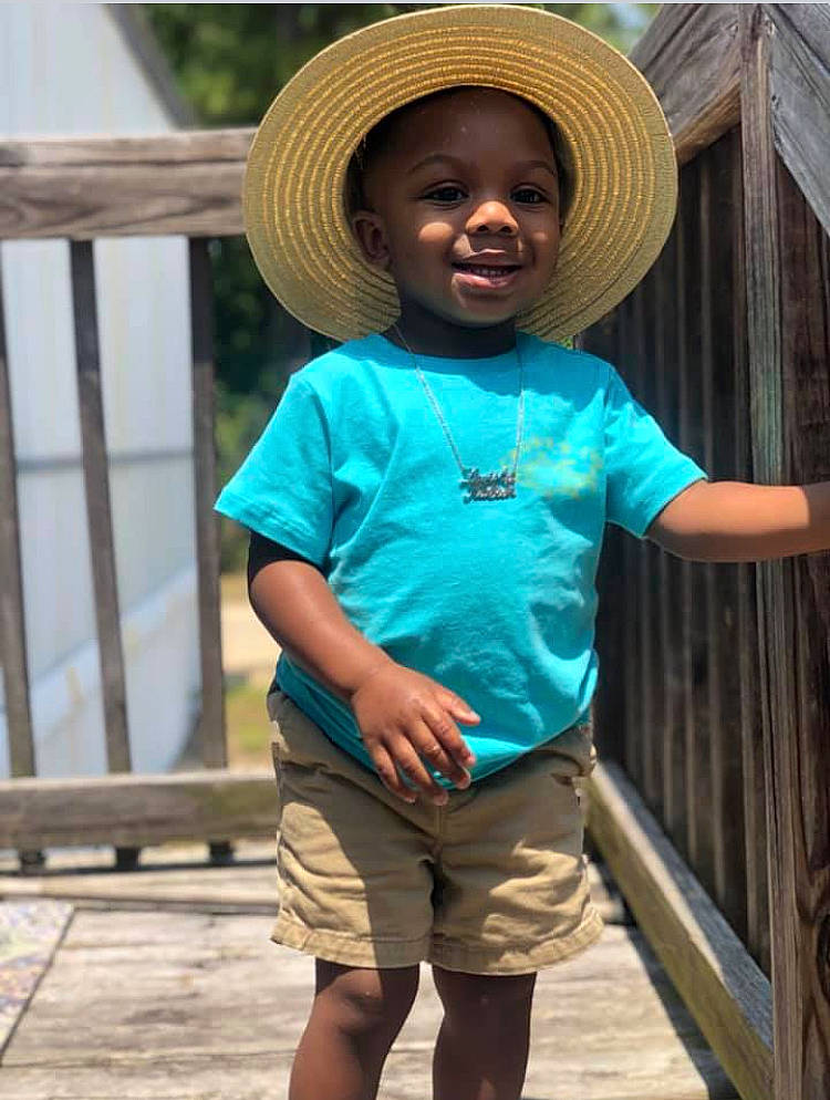 Kaceon is registered to the contest to win money with this photo: child, clothing, fashion_accessory, hat, headgear, joy, person, shorts, sleeve, smile, standing, sun_hat, t_shirt, toddler, turquoise, vacation