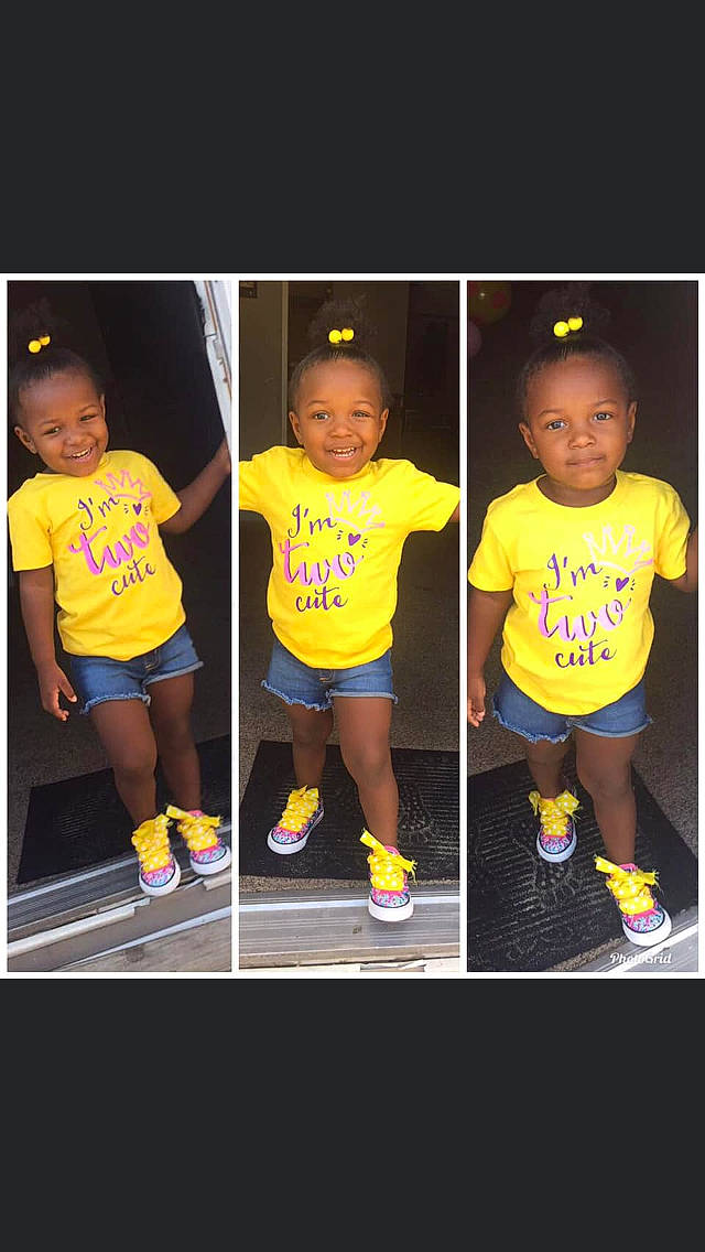 Riah is registered to the contest to win money with this photo: child, facial_expression, footwear, happy, joy, person, photo_caption, play, player, shoe, smile, sportswear, style, t_shirt, team, toddler, uniform, yellow