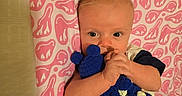 Karson joined the competition — help win amazing prizes! baby, infant, blanket, bedspread, pattern, blue, white, pink, cute, clothing, hand, face, eyes, hair, lying_down, indoor, child, soft_texture, toy, cozy