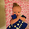 baby, infant, blanket, bedspread, pattern, blue, white, pink, cute, clothing, hand, face, eyes, hair, lying_down, indoor, child, soft_texture, toy, cozy