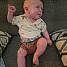 Karson is registered to the contest to win money with this photo: baby, child, couch, pillow, shirt, shorts, barefoot, smiling, indoor, furniture, person, happy, cute, infant, toddler, clothing, patterned, seated, motion, hair