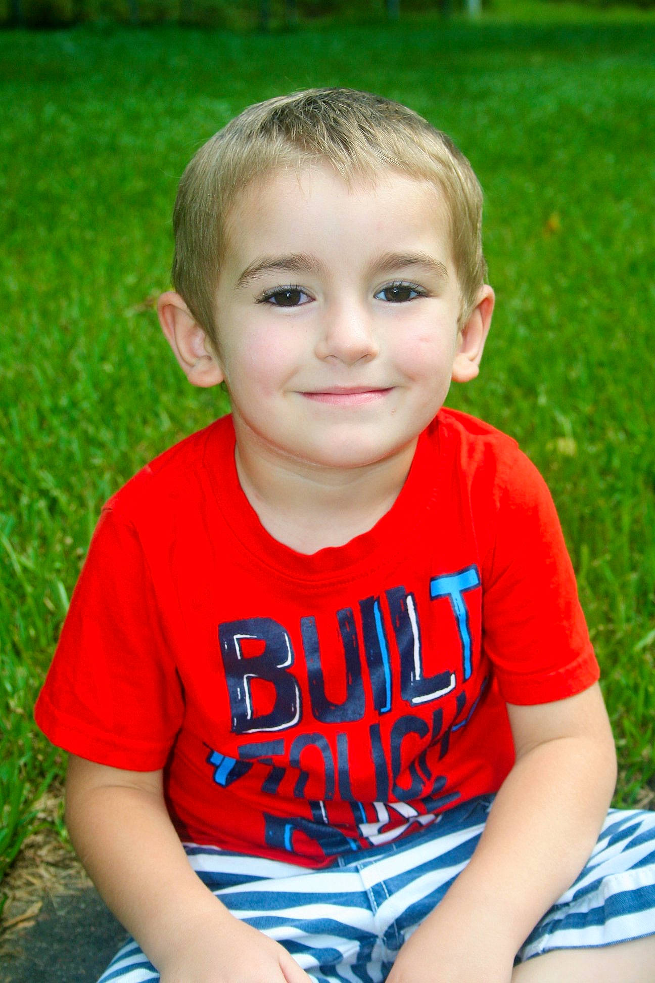 Brantley is registered to the contest to win money with this photo: child, child_model, face, fun, grass, happy, joy, male, person, play, sitting, skin, smile, summer, toddler