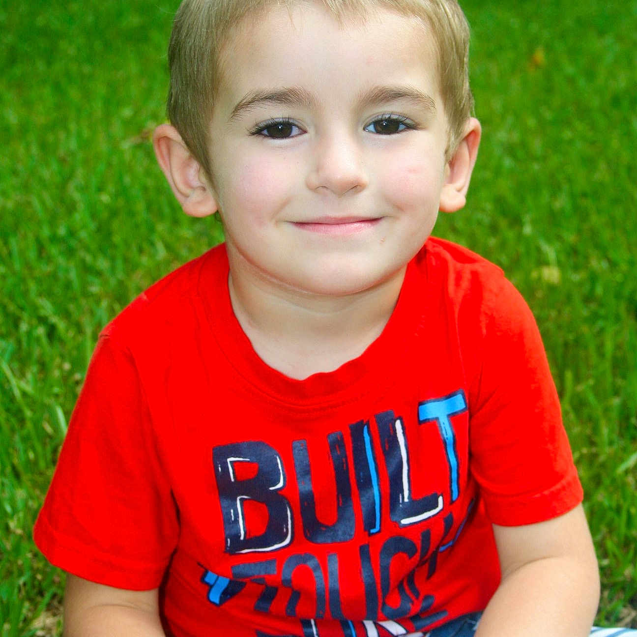 Brantley is registered to the contest to win money with this photo: child, child_model, face, fun, grass, happy, joy, male, person, play, sitting, skin, smile, summer, toddler