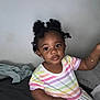 A'Myri joined the competition — help win amazing prizes! toddler, child, girl, indoor, portrait, curly_hair, puffs, beads, rainbow_striped_dress, sitting, blanket, wall, cute, curious, person, skin, face, eyes, small_earrings, bracelet