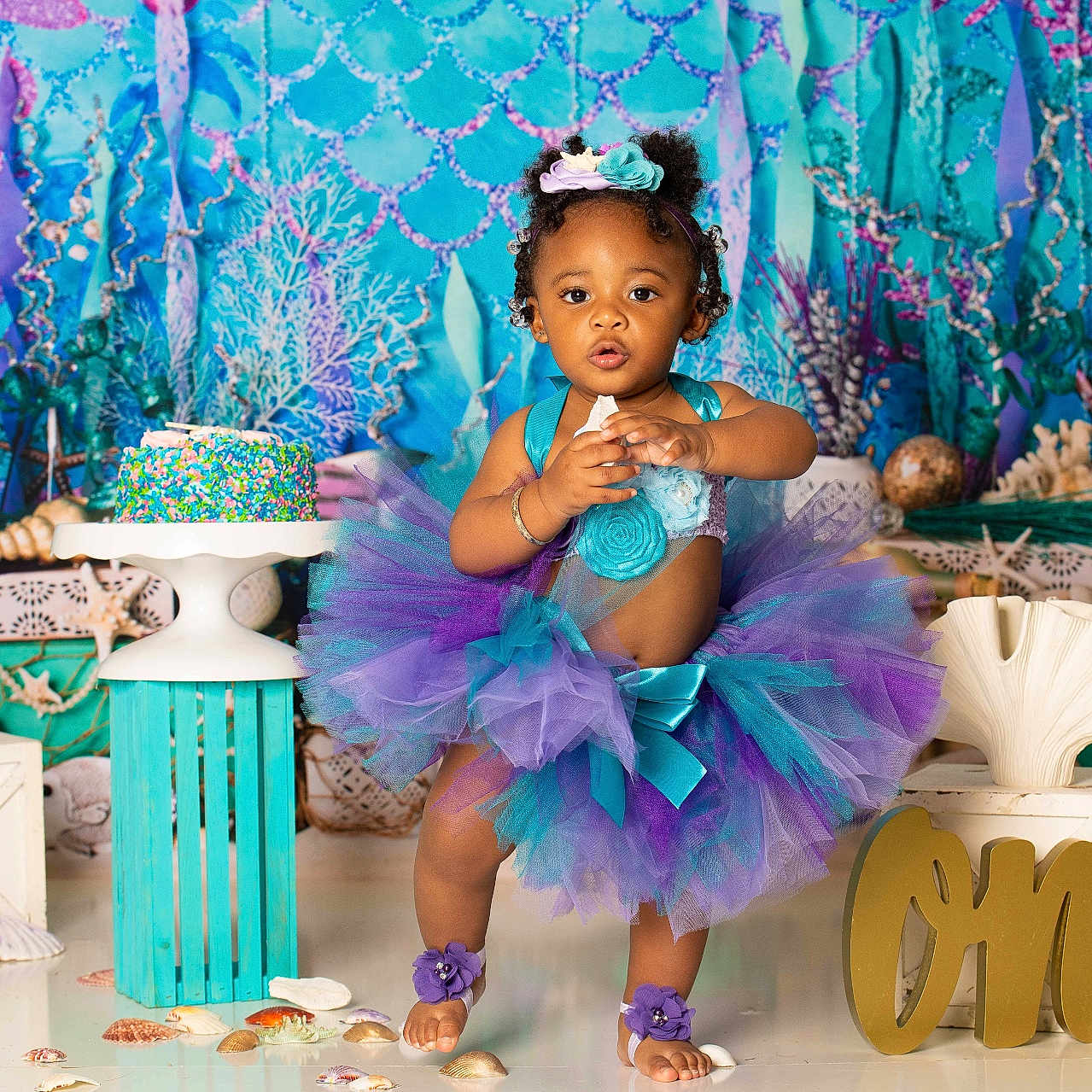 A'Myri joined the competition — help win amazing prizes! barefoot, birthday, cake, celebration, child, colorful, decorations, festive, headband, ocean_theme, one_year_old, party, photography, purple, seashells, smiling, stand, teal, toddler, tutu