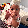 Malani is registered to the contest to win money with this photo: baby, child, indoor, head_wrap, pajamas, blanket, bedroom, cute, thumb_sucking, hand_wave, face, person, sleepwear, soft_lighting, pink_bib, mickey_mouse, white_headwrap, cozy, infant, portrait
