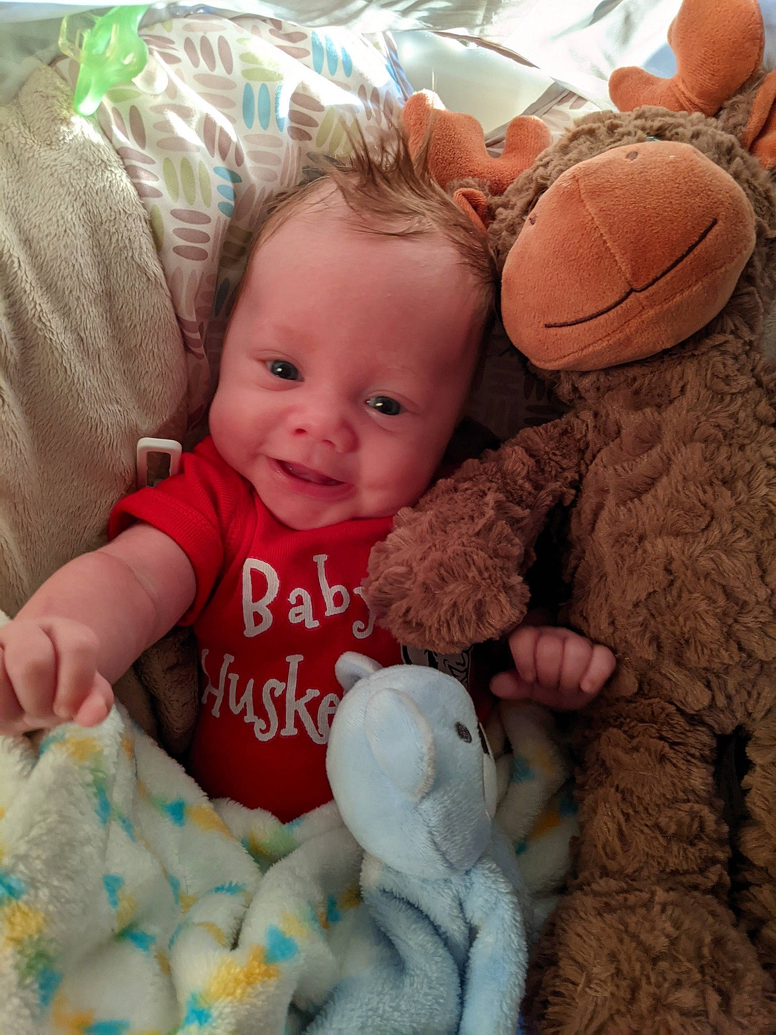 Jarrett is registered to the contest to win money with this photo: arm, baby, baby_products, baby_toddler_clothing, cheek, child, comfort, face, finger, happy, linens, mammal, person, pink, sitting, skin, smile, sock, toddler, toy