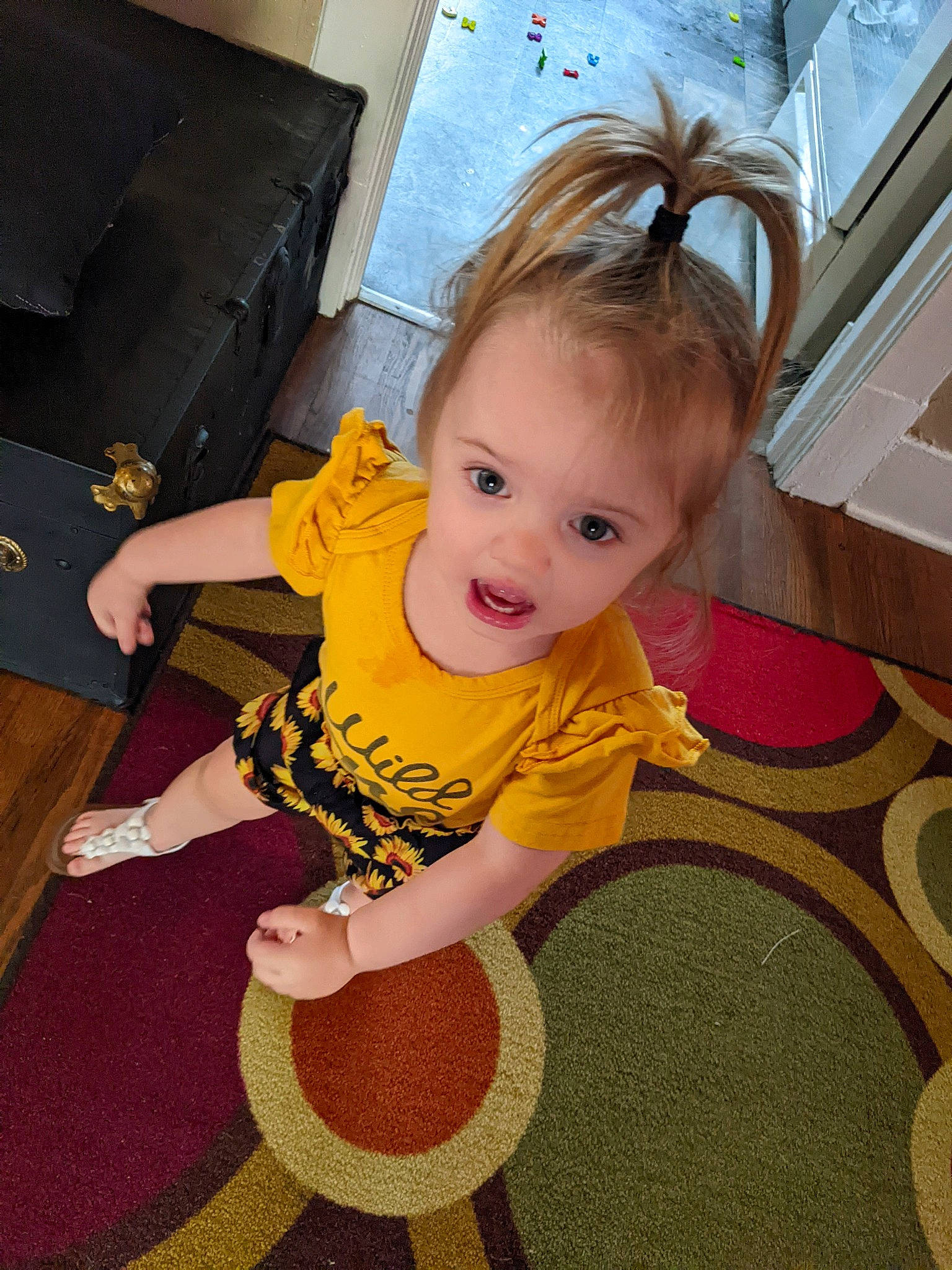 Alora joined the competition — help win amazing prizes! baby, baby_toddler_clothing, cheek, child, couch, eye, floor, flooring, fun, happy, hardwood, human_body, iris, person, room, sitting, skin, smile, t_shirt, toddler