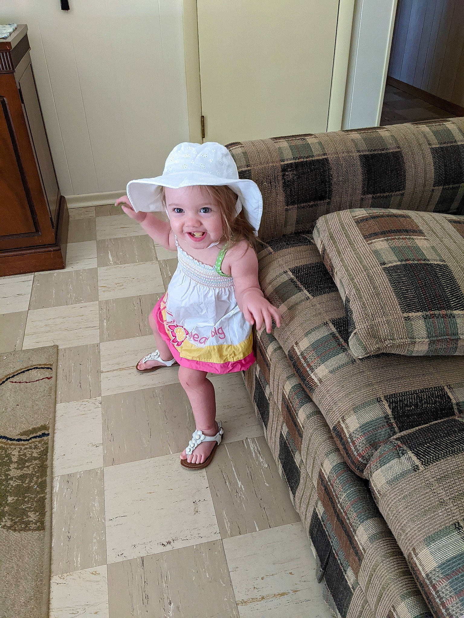 Alora joined the competition — help win amazing prizes! baby, baby_toddler_clothing, child, comfort, couch, design, floor, flooring, grass, hardwood, hat, headwear, joy, magenta, mammal, pattern, person, plaid, sandal, sun_hat