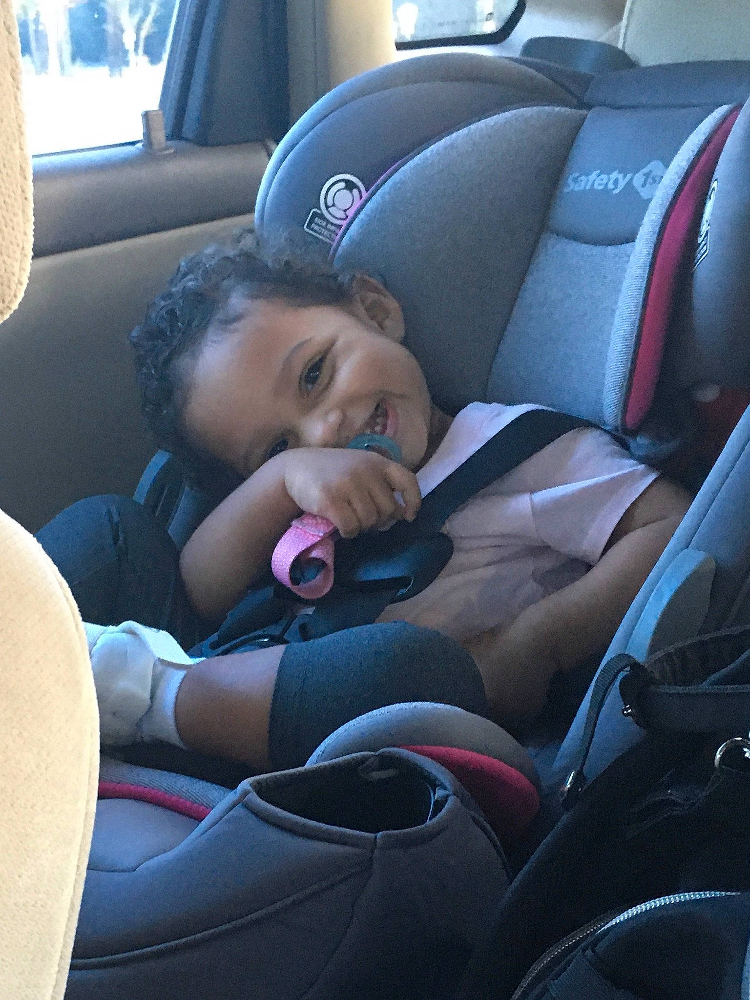 Zariyah is registered to the contest to win money with this photo: auto_part, automotive_design, automotive_exterior, car, car_seat, car_seat_cover, child, comfort, family_car, head_restraint, motor_vehicle, person, personal_luxury_car, smile, steering_part, steering_wheel, tints_and_shades, toddler, vehicle, vehicle_door