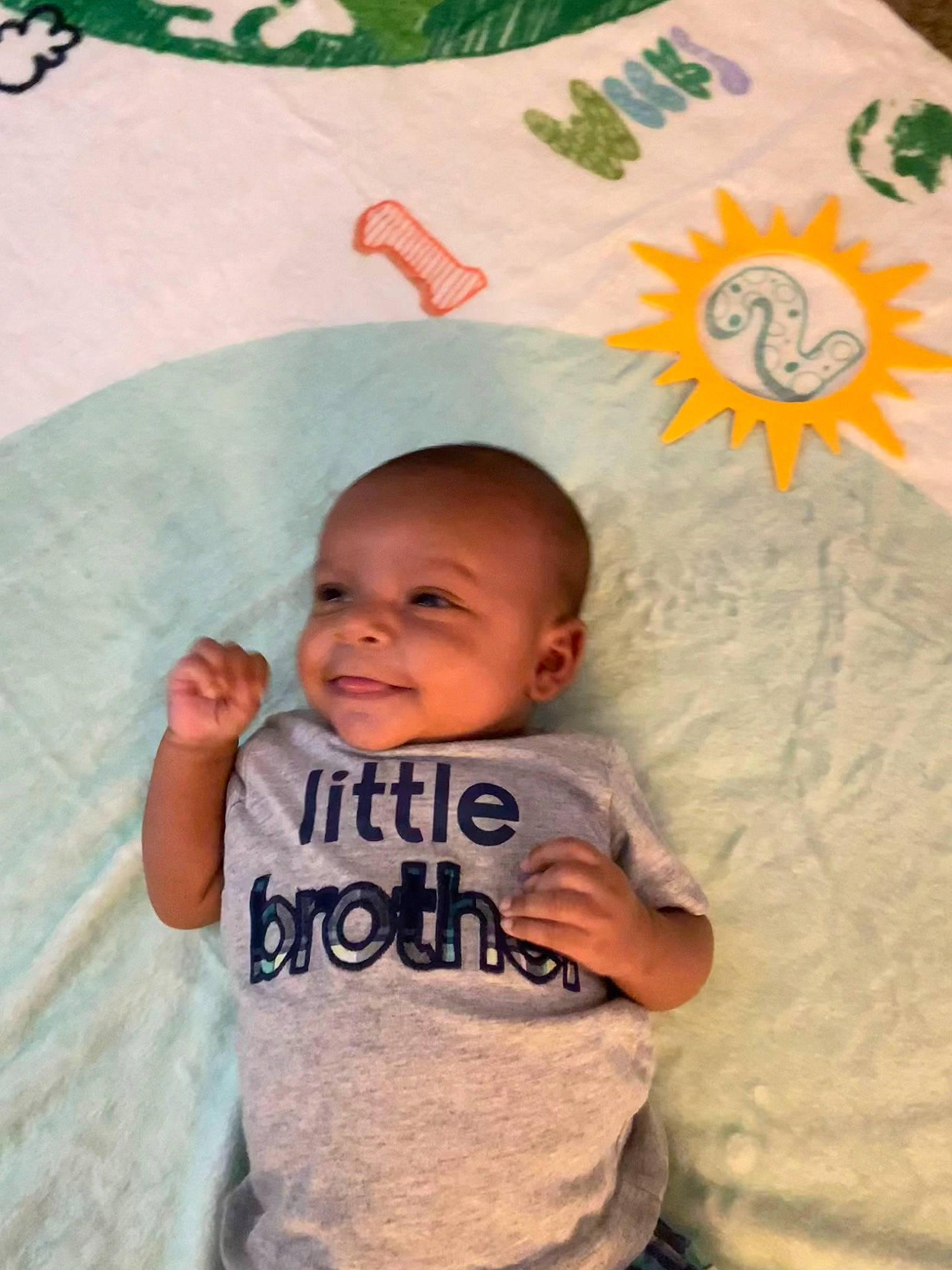 Taben Drake is registered to the contest to win money with this photo: baby, baby_toddler_clothing, cheek, child, fun, green, happy, joy, linens, mouth, nose, people, person, product, room, skin, sleeve, smile, t_shirt, textile