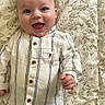 Raphaël participe au concours pour gagner de l'argent avec cette photo : baby, smiling, infant, child, striped_shirt, blue_pants, happy, lying_down, blanket, floral_pattern, cute, face, portrait, hands, button_up_shirt, indoors, person, closeup, skin, head