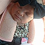 baby, black_bow, blanket, car_seat, child, closeup, clothing, cute, face, headband, indoors, infant, leopard_print, peaceful, pink_cushion, portrait, resting, sleeping, soft_light, young_child