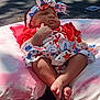 baby, barefoot, blue_clothing, bow, cushion, feet, headband, infant, legs, outdoor, peaceful, pink_cushion, red_clothing, resting, shadow, skin, sleeping, stars_pattern, sunlight, white_clothing