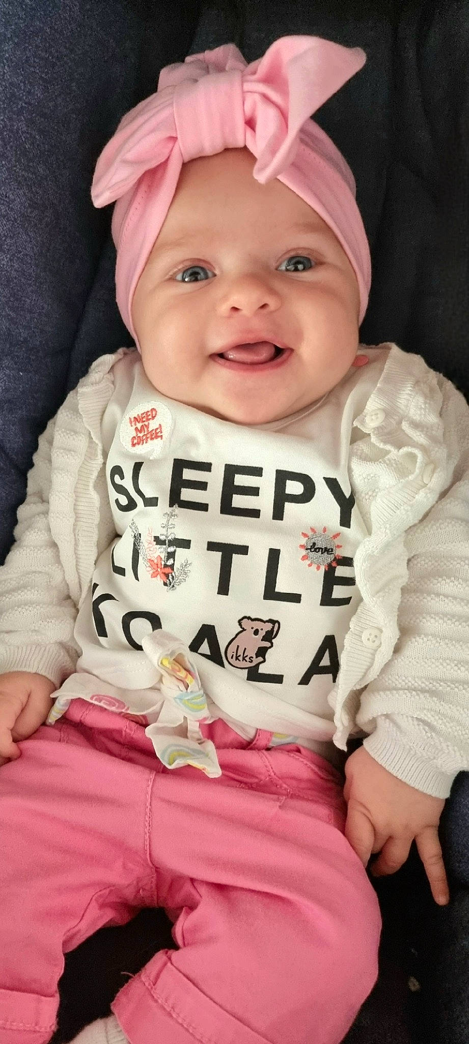Ella participe au concours pour gagner de l'argent avec cette photo : arm, baby, baby_toddler_clothing, cap, cheek, collar, comfort, eye, finger, happy, head, headwear, human_body, outerwear, person, pink, skin, sleeve, smile, t_shirt