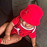 Zyair joined the competition — help win amazing prizes! baby, child, infant, red_clothing, red_hat, cap, sportswear, jordan_logo, sitting, couch, indoor, portrait, face, partially_hidden_face, arm, hand, leg, casual, fashion, photography