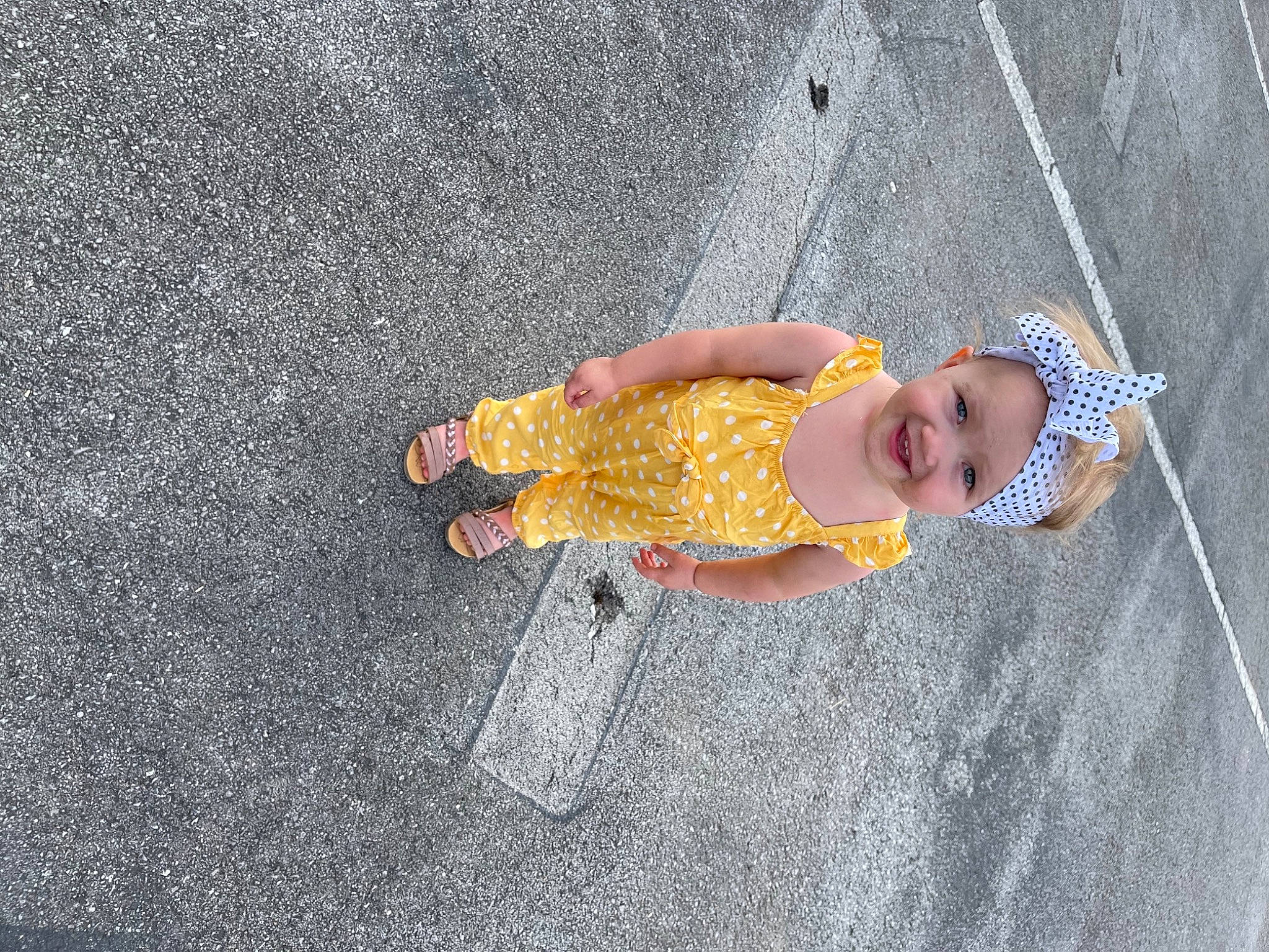 Chloe Ealy is registered to the contest to win money with this photo: asphalt, baby, baby_toddler_clothing, child, circle, concrete, floor, flooring, fun, grass, headwear, human_leg, joy, pattern, person, plant, play, road_surface, sand, sidewalk