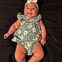 Emersyn joined the competition — help win amazing prizes! baby, smiling, infant, headband, floral_outfit, lying_down, black_background, cute, chubby_arms, chubby_legs, happy, person, portrait, clothing, indoors, skin, child, cute_expression, baby_girl, head