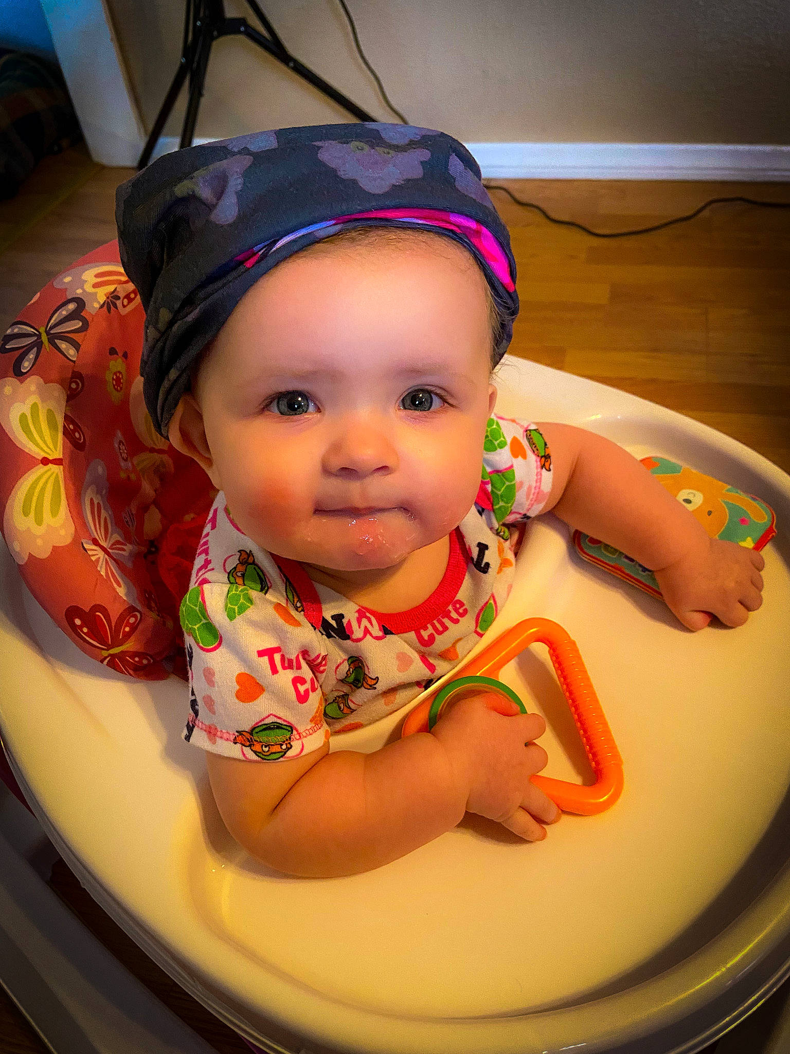 Maeve joined the competition — help win amazing prizes! baby, baby_toddler_clothing, cap, chair, cheek, child, chin, circle, eye, eyebrow, facial_expression, fashion_accessory, fun, happy, headwear, helmet, iris, person, pink, sitting