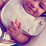 Adonis is registered to the contest to win money with this photo: baby, smiling, bib, hand, face, infant, child, seat, comfort, indoors, closeup, skin, expression, young, cute, human, portrait, clothing, relax, babygear