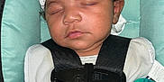 Adonis is registered to the contest to win money with this photo: baby, sleeping, car_seat, hat, pacifier, child, infant, straps, clothing, closeup, seatbelt, resting, cute, indoors, person, headwear, comfort, peaceful, young_child, safety