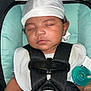 baby, sleeping, car_seat, hat, pacifier, child, infant, straps, clothing, closeup, seatbelt, resting, cute, indoors, person, headwear, comfort, peaceful, young_child, safety