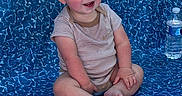 Duston joined the competition — help win amazing prizes! baby, barefoot, blue_eyes, casual, child, cute, happy, indoor, infant, onesie, patterned_surface, person, playful, portrait, rosy_cheeks, short_hair, sitting, smiling, water_bottle, young