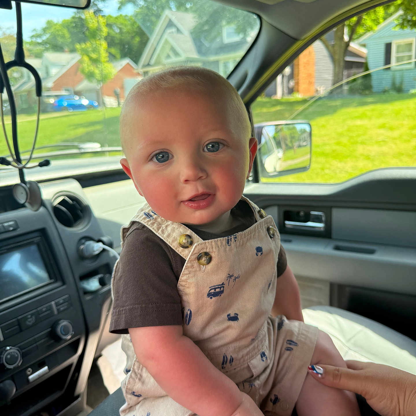 Duston joined the competition — help win amazing prizes! baby, child, infant, car_interior, overalls, blue_eyes, hand, seat, window, suburban, daylight, person, cute, clothing, portrait, smiling, skin, short_hair, vehicle, seatbelt