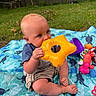 Duston joined the competition — help win amazing prizes! baby, child, toys, blanket, outdoor, grass, fence, inflatable_toy, yellow, blue, purple, red, green, cute, playtime, summer, sitting, toddler, nature, happy
