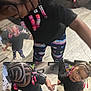 barefoot, black_tshirt, braided_hair, casual, child, collage, colorful_beads, curious_expression, cute, fashion, fun, indoor, multiple_views, outdoor, patterned_pants, person, playful, small_person, toddler, wood_floor
