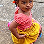 braided_hair, casual, child, childhood, concrete, cute, expression, fashion, girl, orange_hair_clips, outdoor, person, pink_dress, playful, portrait, pose, side_view, summer, yellow_skirt, young