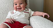Coast joined the competition — help win amazing prizes! baby, chair, child, clothing, cozy, cute, furniture, happy, home, indoors, infant, person, playful, portrait, red_shorts, relaxing, smiling, texture, white, wooden_blocks